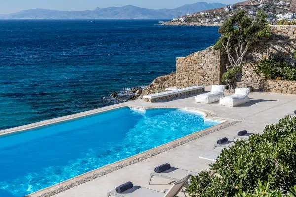 Typical white Mykonos architecture overlooking the Aegean Sea, in a luxury villa with private pool.