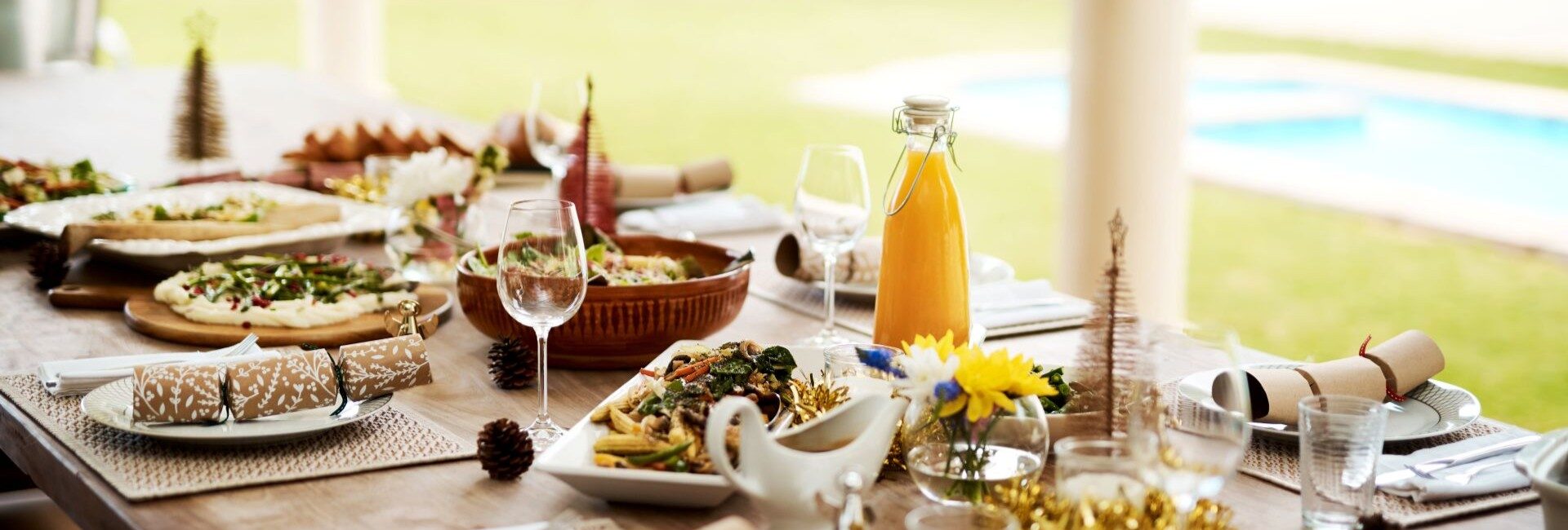 Elegant Christmas table set in a villa by the pool in St Barts, one of the best Christmas vacation destinations.