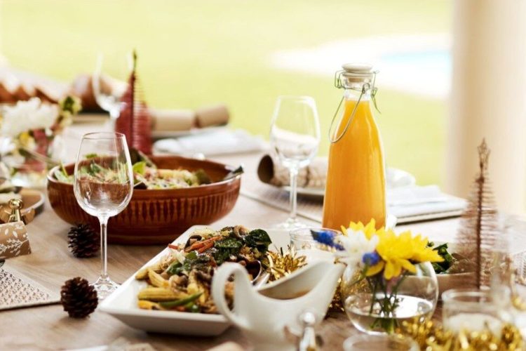 Elegant Christmas table set in a villa by the pool in St Barts, one of the best Christmas vacation destinations.